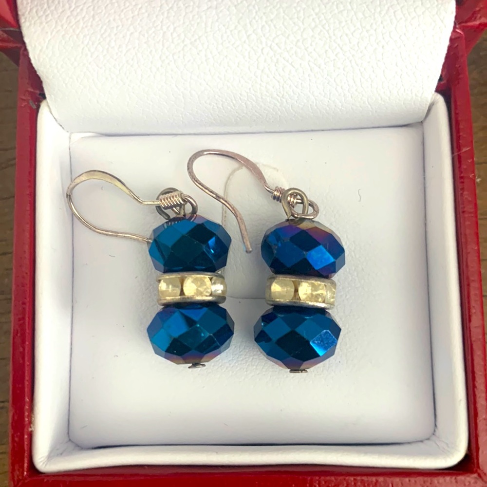 Blue iridescent earrings with crystal beading in the center.
